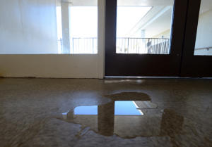 Water puddles on the top floor at the Hacienda public housing apartment complex in Richmond, Calif. on Wednesday, Feb. 19, 2014. (Kristopher Skinner/Bay